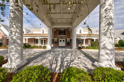 Entrance view of SummerHouse Bay Cove with columns and landscaping