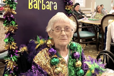 Resident celebrating with colorful decorations.