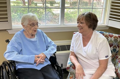 A staff member talking with a resident in a common area