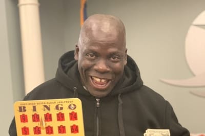 Resident celebrating a bingo win during an activity.