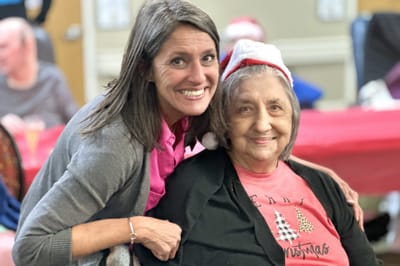 Resident and staff member celebrating together