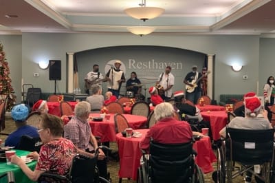 Residents enjoying live music performance in a festive common area