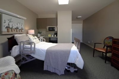 A private resident room with a bed and amenities