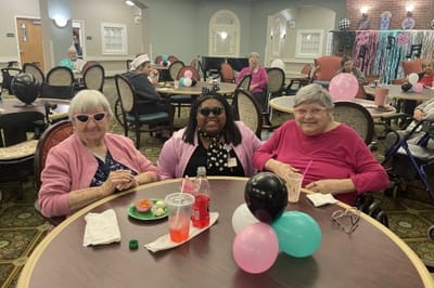 Residents enjoying a social activity with snacks and drinks