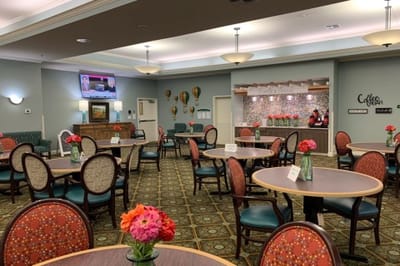 Bright dining room with tables and flowers
