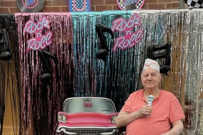 Resident participating in a Rock 'n' Roll themed activity
