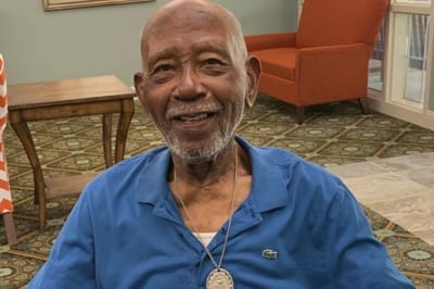 Senior resident smiling in a common area