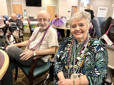 Residents participating in a festive activity with beads
