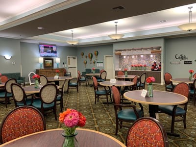 Bright dining area with tables and floral arrangements