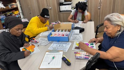 Residents engaging in a coloring activity at a table