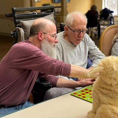 Residents engaging in a bingo game with staff support