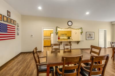 Bright common area with wooden dining table