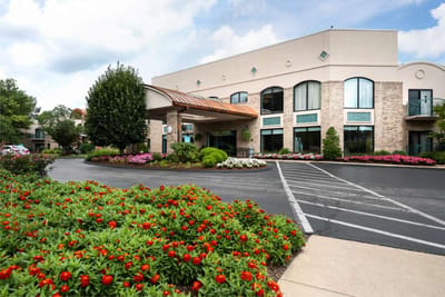Front entrance of Delmar Gardens with landscaped gardens