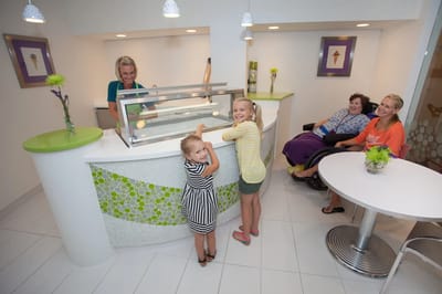 Staff serving ice cream to residents in a bright activity area