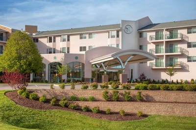 Exterior view of Delmar Gardens with landscaped garden
