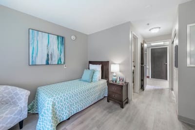 A private resident room with a bed and decor