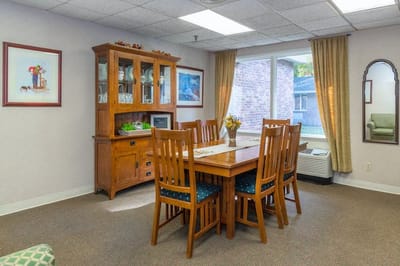 Bright common area with dining table and windows