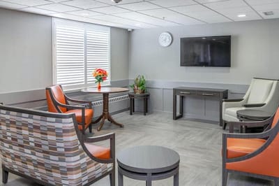 Bright common area with seating and a TV