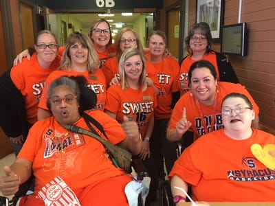 Staff and residents celebrating with popcorn and team shirts