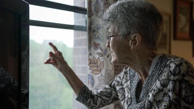 Resident looking out the window with interest