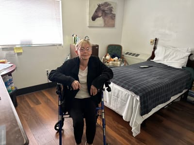 Resident in a wheelchair in their private room