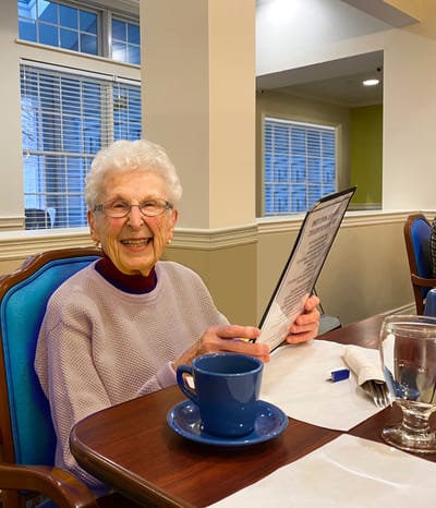 Resident enjoying a menu in the dining room