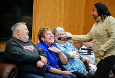 Residents enjoying a lively performance in the common area