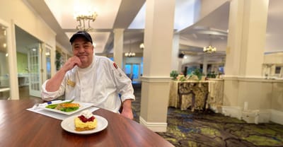 Chef presenting a meal in the dining room