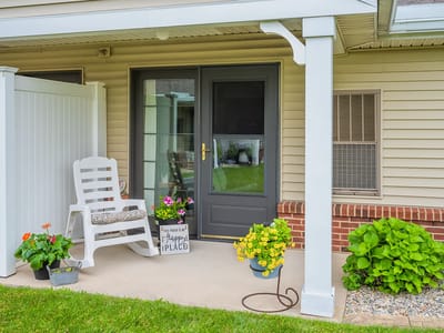 Cozy porch area with flowers and a chair