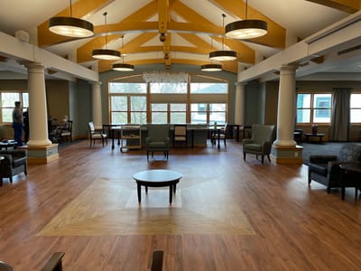 Bright common area with seating and large windows