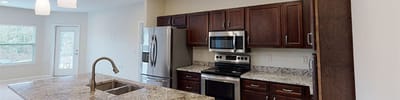 Modern kitchen space with cabinetry and appliances