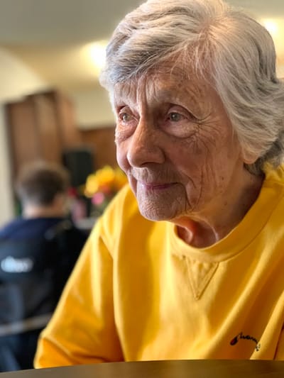 Portrait of an elderly woman in a bright interior