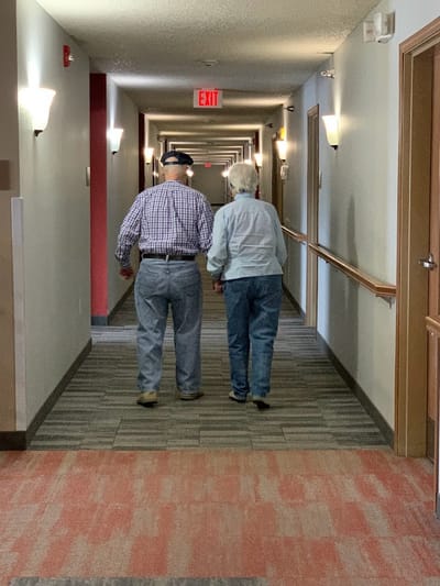 Two residents walking down a hallway