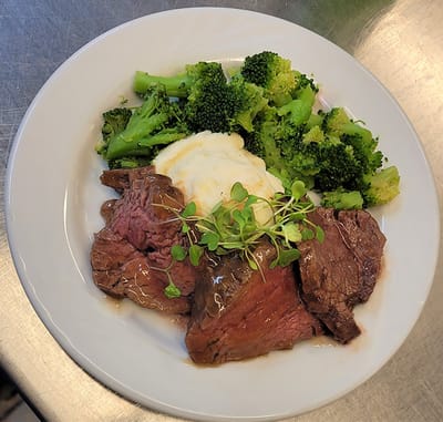 Plate of roast beef with vegetables and mashed potatoes