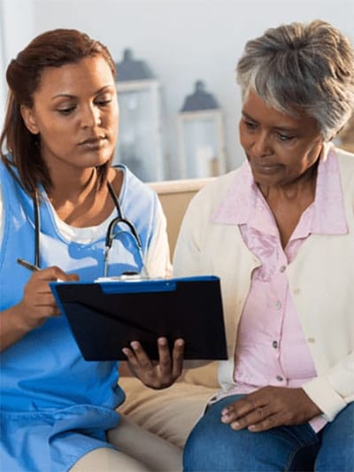 Caregiver consulting with a senior resident