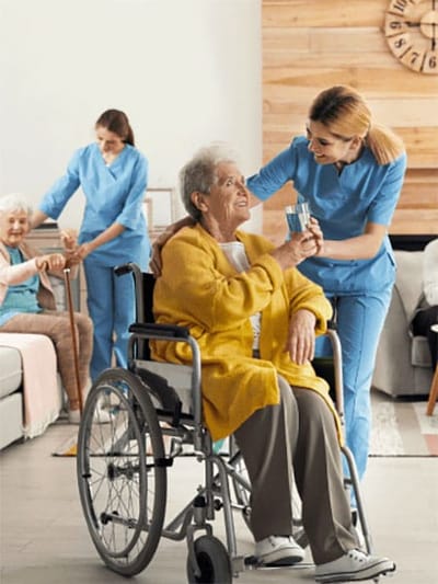 Staff assisting residents in a bright common area