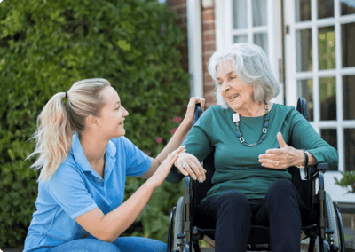 Caregiver interacting with a resident in a wheelchair