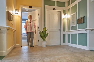 A resident standing in a hallway with colorful walls