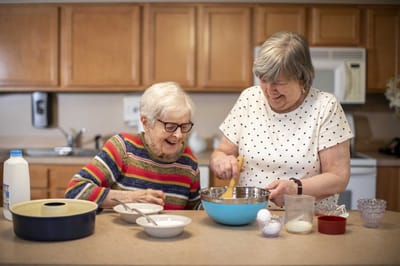 Residents enjoying a cooking activity in the kitchen