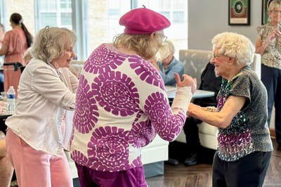 Residents dancing in a lively activity room