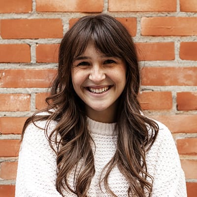 Smiling woman against a brick wall