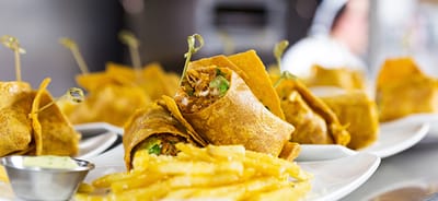Plated food with wraps and fries