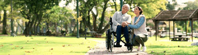 A resident and staff member enjoying outdoor time in a park