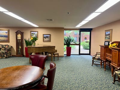 Common area with piano, seating, and plants