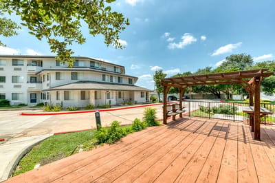 Outdoor seating area with facility building in background