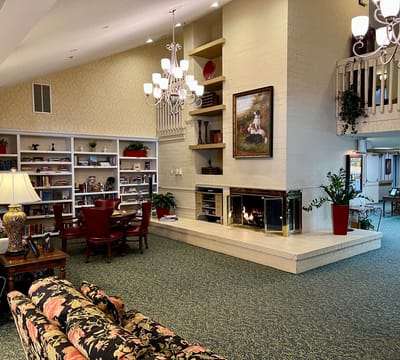 Cozy common area with bookshelves and a fireplace