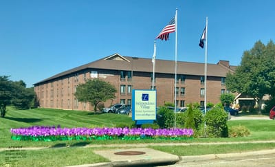 Exterior view of Independence Village with landscaped entrance