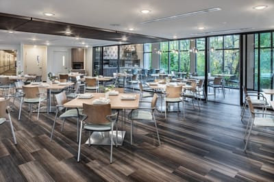 Bright dining room with tables set for meals