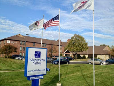 Exterior view of Independence Village with flags and signage