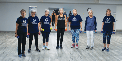 Residents participating in a fitness class with weights